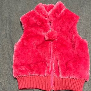 Toby vest with pom-pom on zipper.  New without tags.